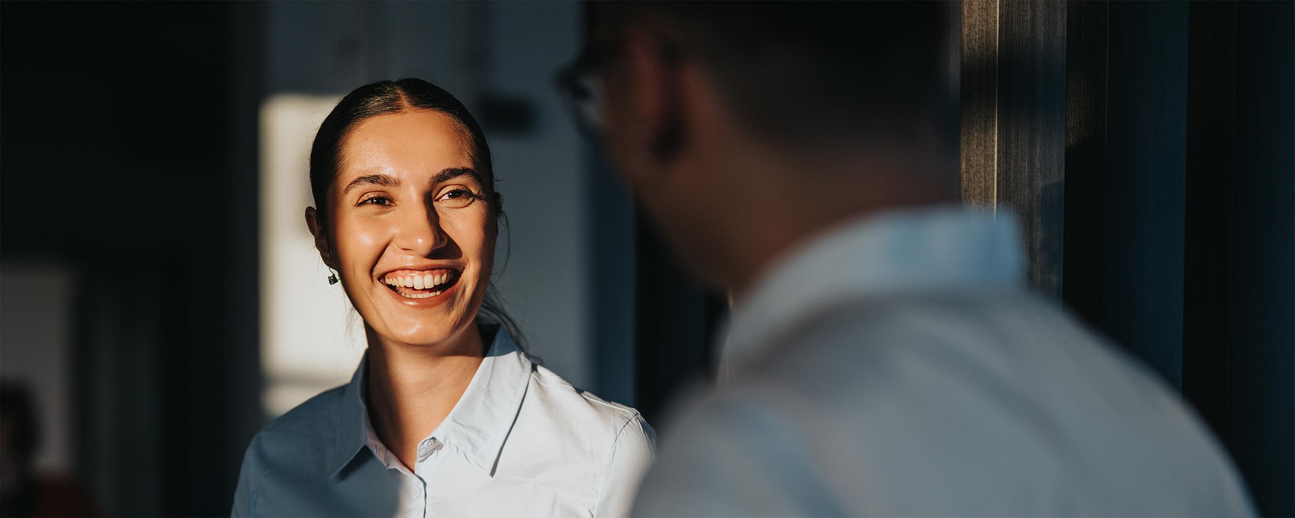 Diverse business people communicating in office hallway setting